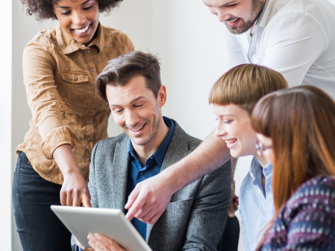 The RAPTEK team collaborating around a tablet